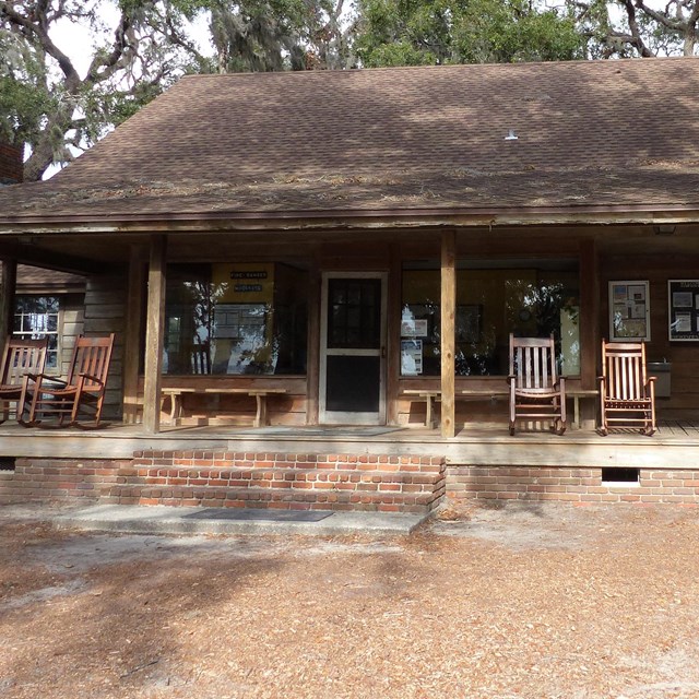 Wooden ranger station with large front porch and rocking chairs