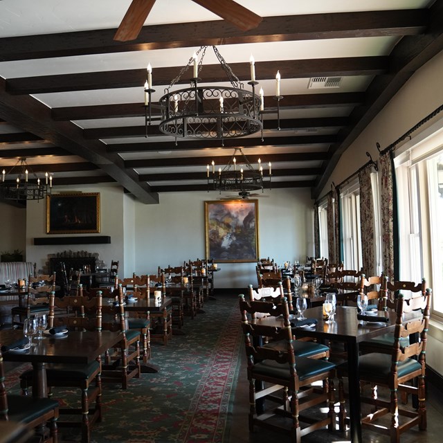  A wooden, Spanish-style dining room interior at the Inn's Dining Room restaurant. 