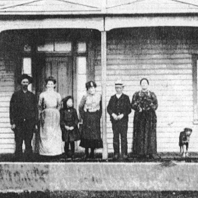 Historic photo of a family standing on the porch of the Ferry House