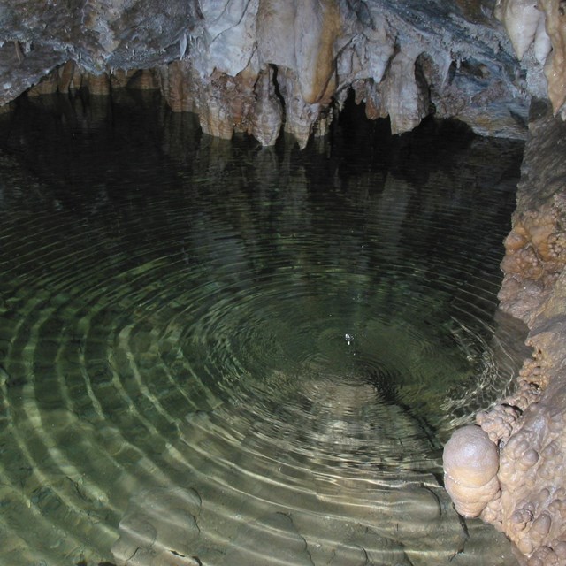 Water ripples on a pool in a cave.