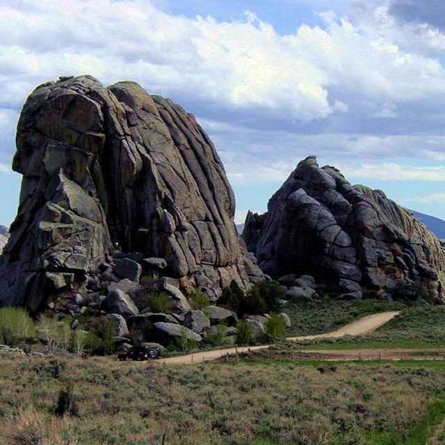 Massive rock formations called bread loaves dot the landscape next to a trail.