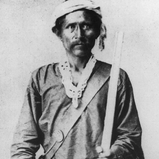 Photograph of Navajo leader Barboncito holding rifle with leather strap across shoulder