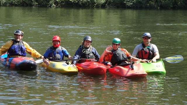 five kayakers on the river