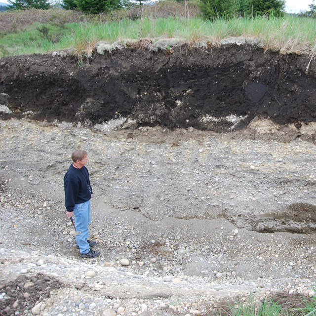 soil scientist examining a soil profile