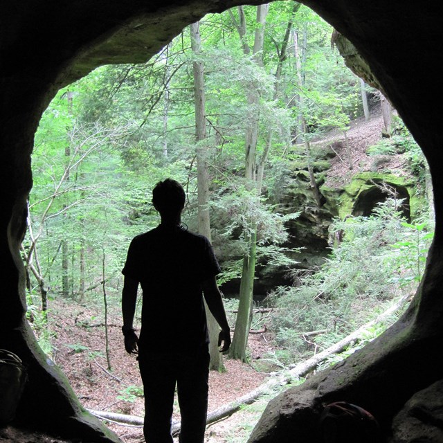 person in cave entryway