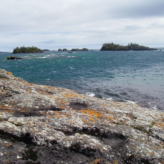 Lichen-covered bedrock and the blue lake