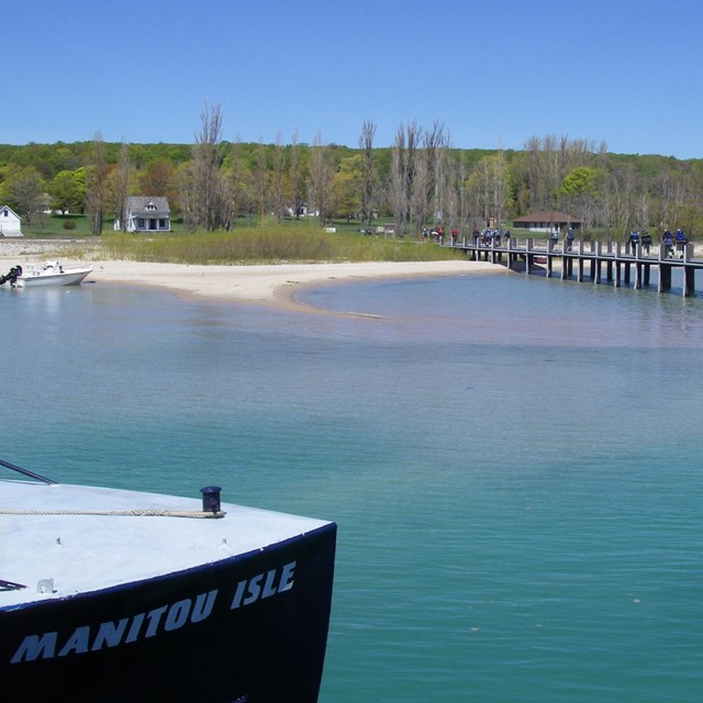 Boat in the harbor and people on dock