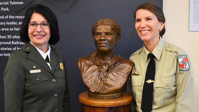 Park Managers standing with bronze bust of Harriet Tubman