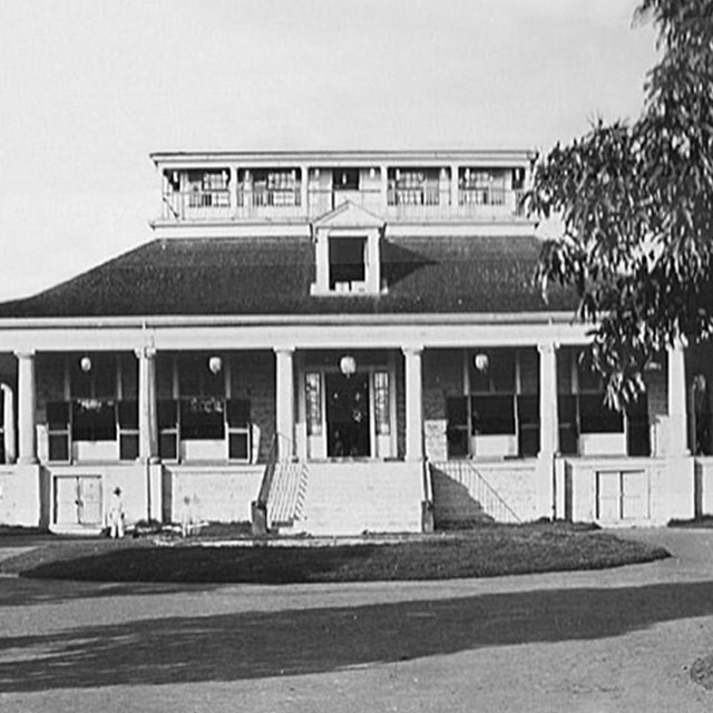 B&W photo of white pavilion with palm trees