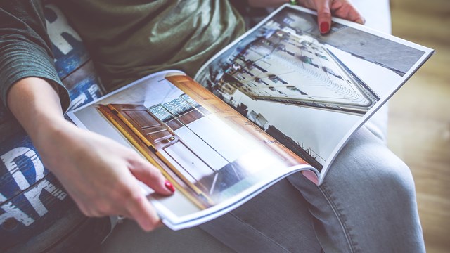 A photo of a woman holding a magazine