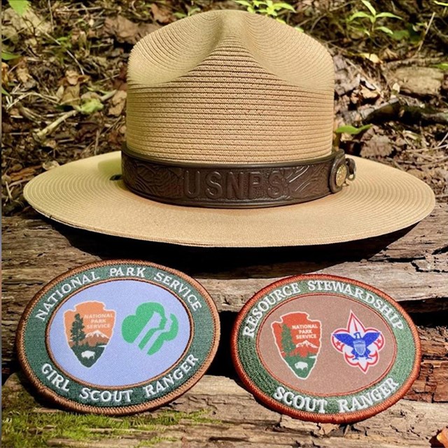 A flat ranger hat with two patches for Girls Scouts and Boy Scouts