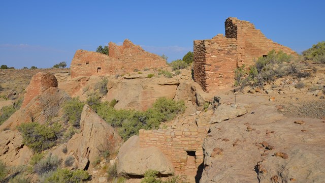 stone structures built in and around a small canyon head