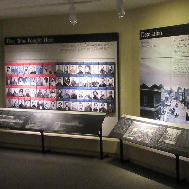 2 adjacent interior walls with large information panels titled They Who Fought Here & Desolation.
