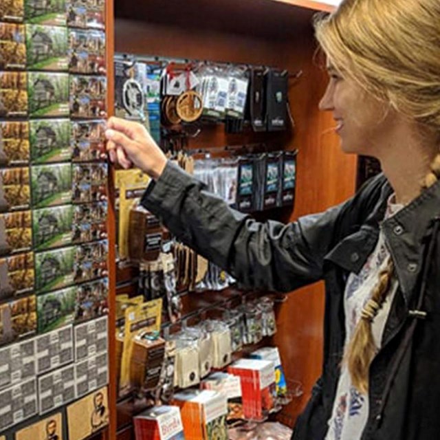 girl looking at magnets at bookstore