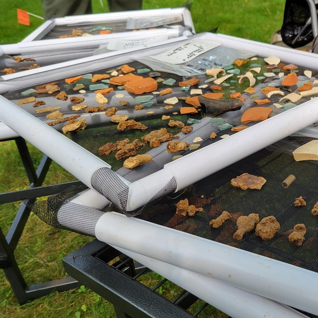 Trays of archeological items during a 2022 dig.