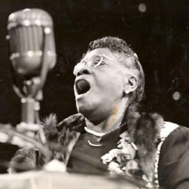 Bethune speaks into a microphone