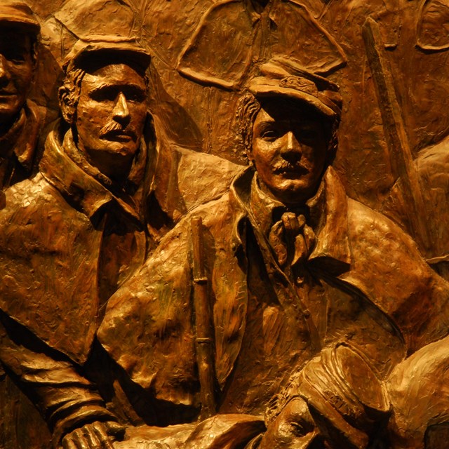 Color image of bronze relief sculpture showing five civil war soldiers.