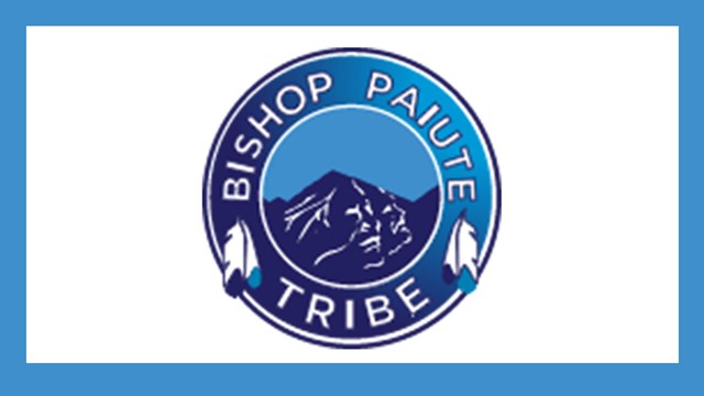 Blue circle logo with mountain and feathers