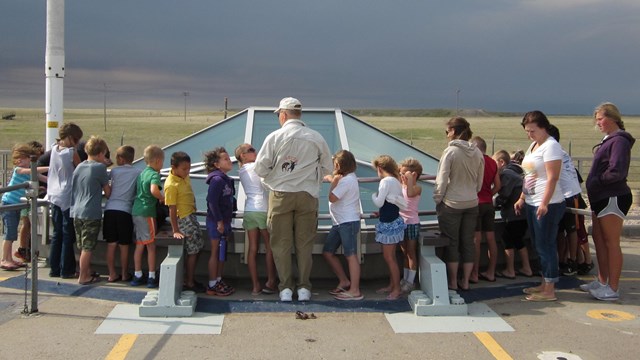 Students and a volunteer stand at the Delta-09 missile silo