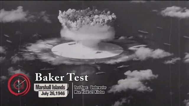 Screen shot of exhibit film showing a mushroom cloud explosion at sea