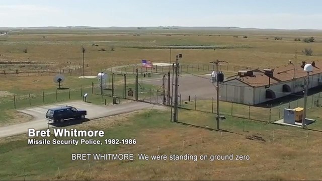 Screen shot of a SUV pulling up to the gate of a launch control facility