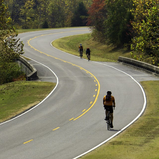Cyclists pedal through the rolling hills of the parkway.