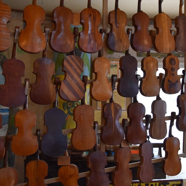 Violins hang from the ceiling.