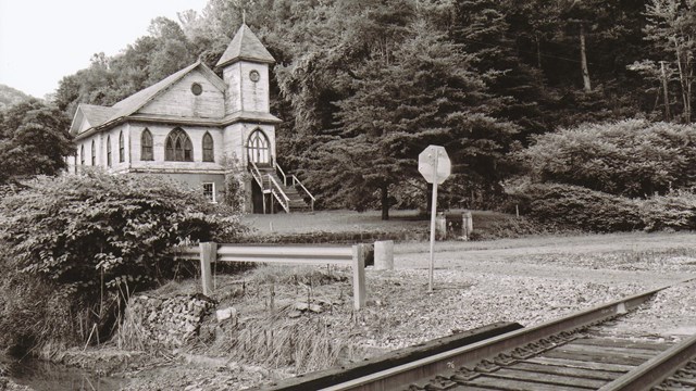 black and white photo of building and RR tracks