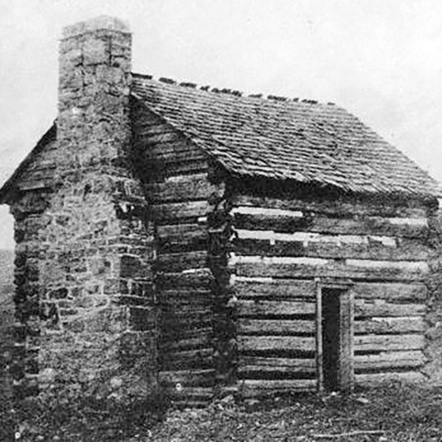 historic photo of a log cabin