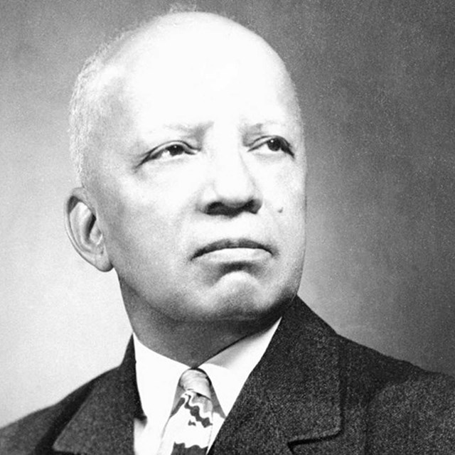 Black and white image of an older African American man in a suit and tie
