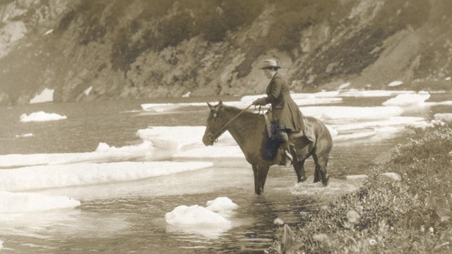 Person on a horse crossing a lake 