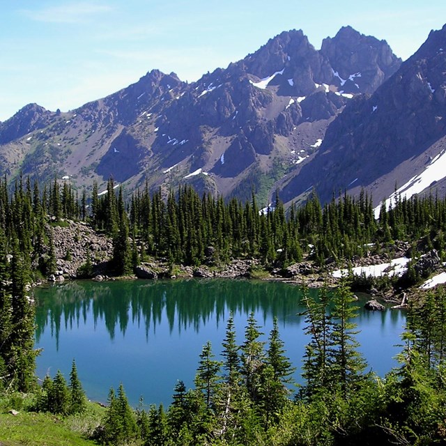 Alpine lake surrounded by mountains.