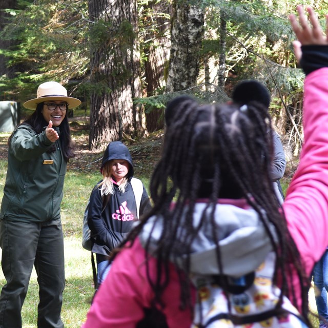 Ranger pointing to a child with her hand in the air