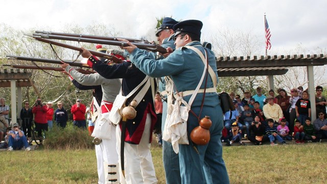 Living historians performing a musket demonstration