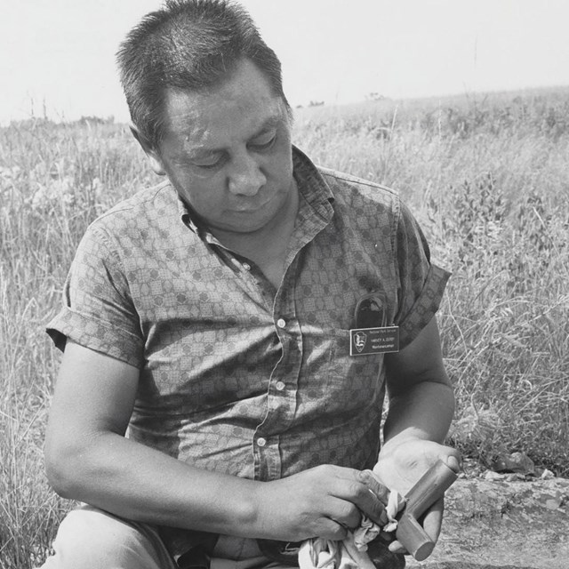 A photo of a carver at Pipestone National Monument