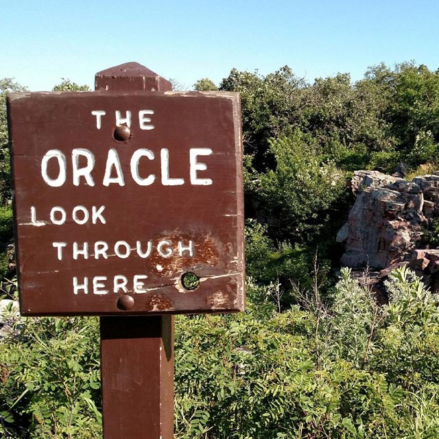 A photo of a sign on a post at The Oracle, a rock feature
