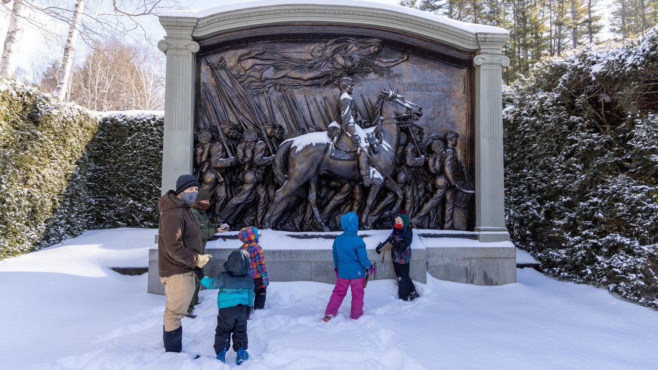people in front of Civil War sculpture in the winter