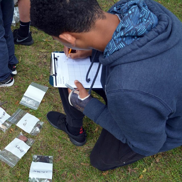 A student filling out a map in an archaeology program