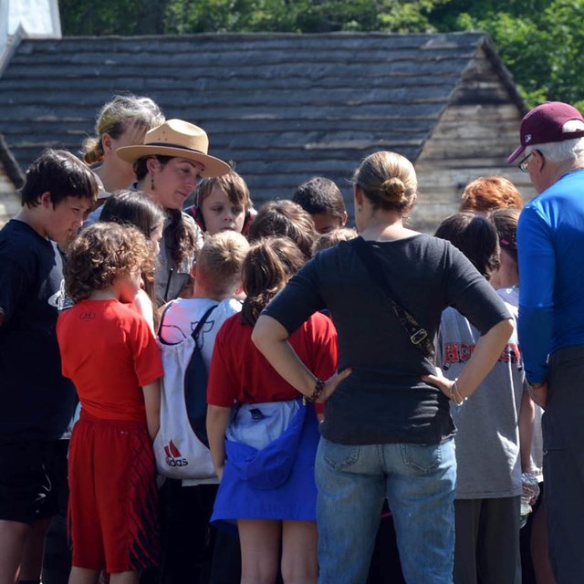 A ranger speaking to a school group at the Saugus Iron Works