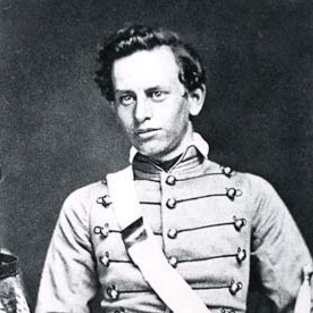 Black and white photo of a young man in a military uniform