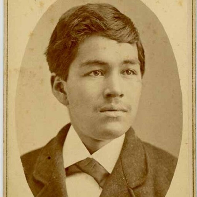 Sepia toned photograph of a young man in inset paper