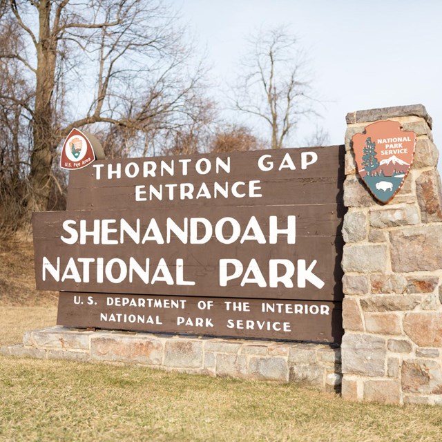 A large sign bordered by stone reads: Thornton Gap Entrance, Shenandoah National Park.