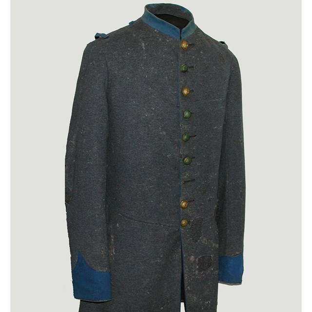 A grey coat with a light blue collar and cuffs with gold buttons down the center.