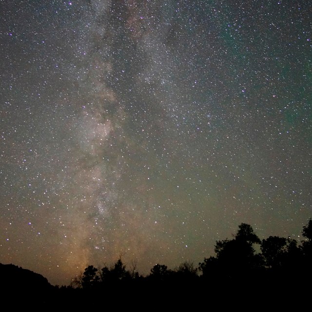 The Milky Way galaxy across a starry night sky.