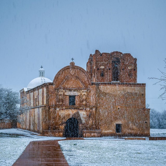church with snow falling