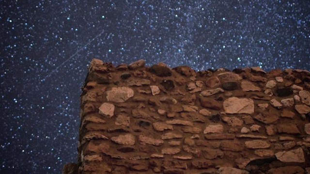 Image of the Citadel Room at Tuzigoot Pueblo with a starry sky background. 