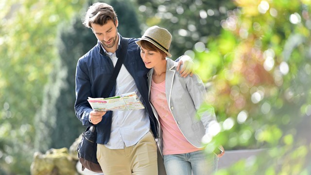 A man and woman reading a map outdoors.