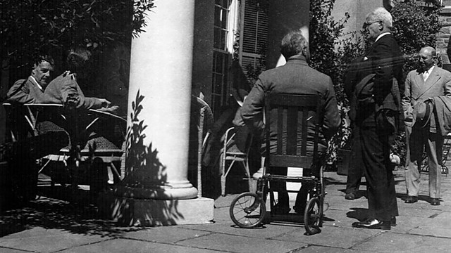 FDR seated in a wheelchair on a terrace.