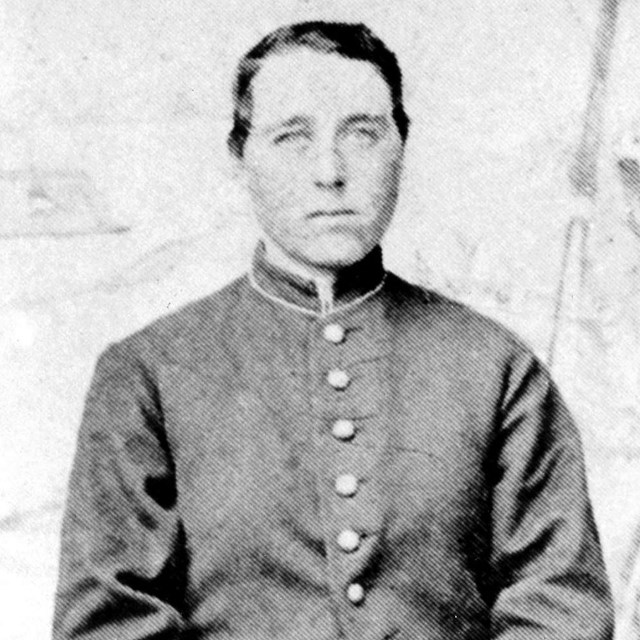 A woman dressed as a man in civil war uniform.