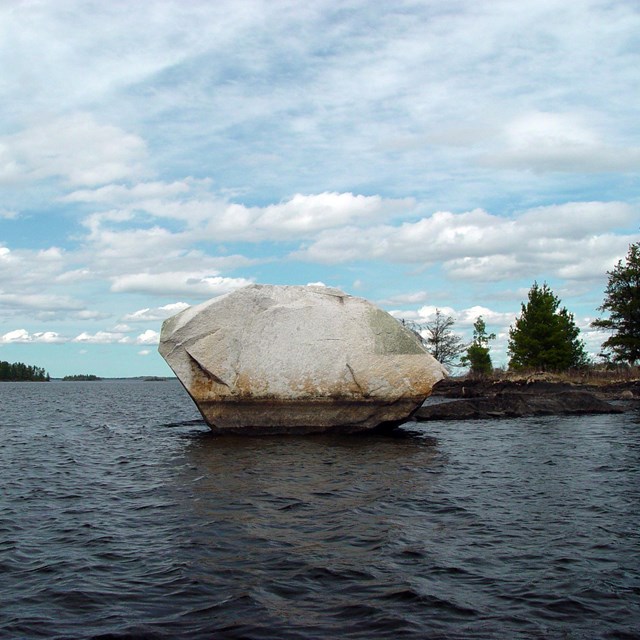 Large rock surrounded by water